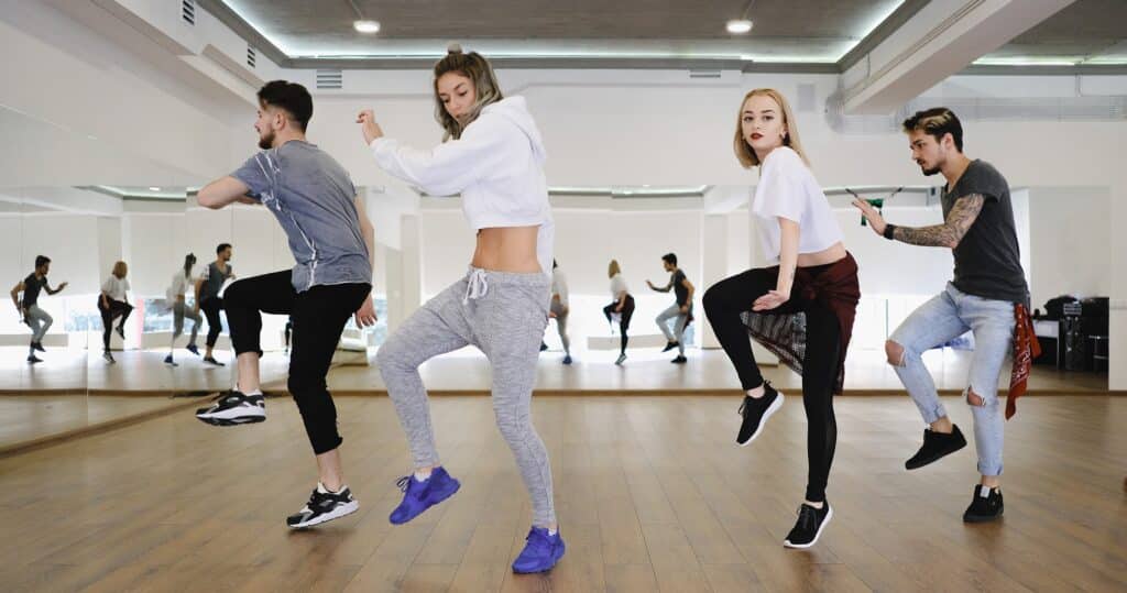 Group of young modern dancers dancing in the studio